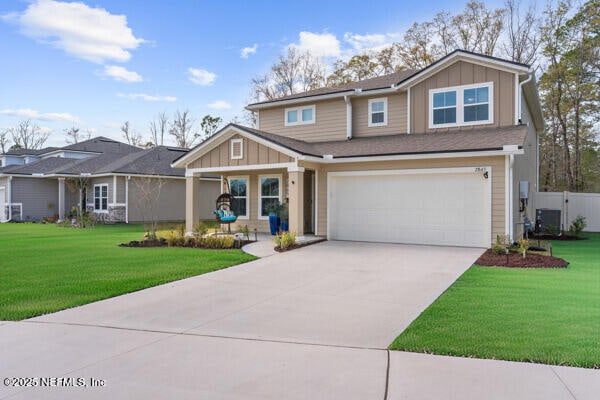 view of front of property featuring board and batten siding, concrete driveway, and a front lawn