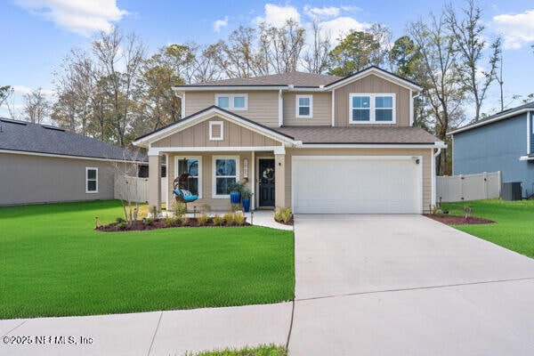 view of front of home featuring board and batten siding, concrete driveway, and a front yard