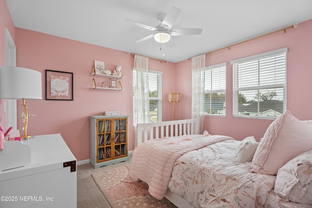 bedroom with baseboards, light carpet, and a ceiling fan