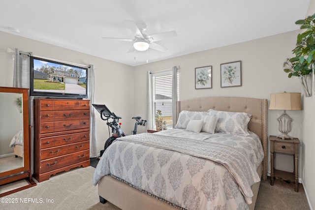 bedroom with a ceiling fan and carpet