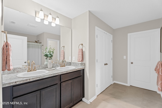 bathroom featuring double vanity, baseboards, a shower with curtain, and a sink