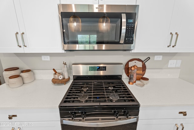 interior details with white cabinets, light stone countertops, and stainless steel appliances