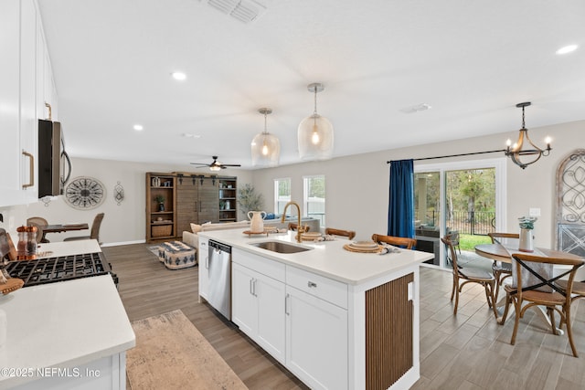 kitchen with visible vents, a sink, light countertops, white cabinets, and appliances with stainless steel finishes