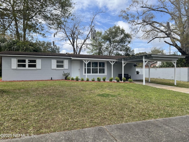 single story home featuring concrete driveway, a front lawn, and an attached carport