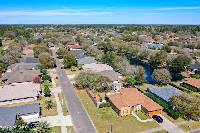 birds eye view of property featuring a residential view and a water view