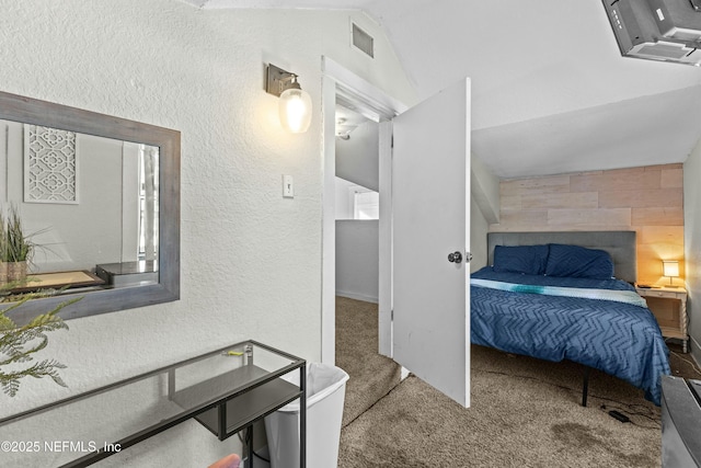 810 Calvert St, Jacksonville, FL 32208 - carpeted bedroom with visible vents, vaulted ceiling, and a textured wall