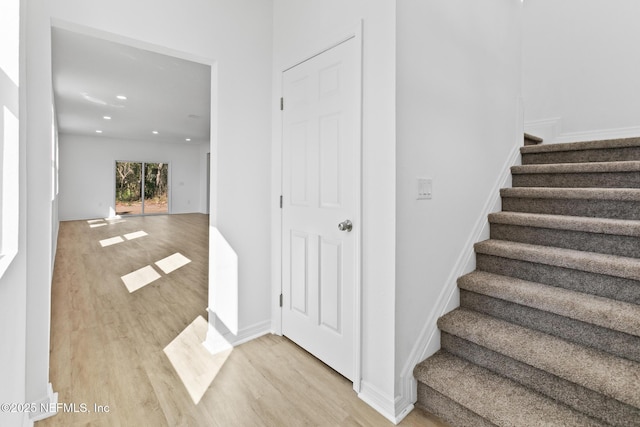 stairs featuring recessed lighting, baseboards, and wood finished floors