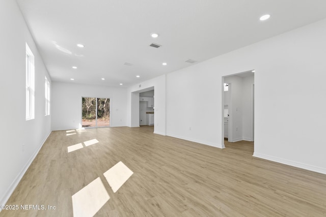 unfurnished living room featuring recessed lighting, light wood-type flooring, baseboards, and visible vents