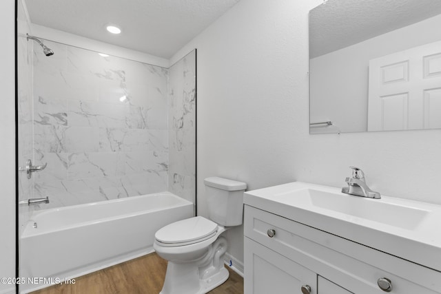 full bath with a textured ceiling, toilet, shower / bathtub combination, and wood finished floors