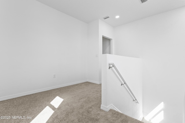 carpeted empty room featuring visible vents, recessed lighting, and baseboards