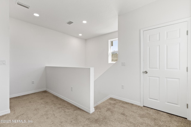 empty room featuring recessed lighting, visible vents, carpet floors, and baseboards