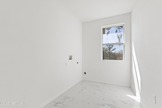 spare room featuring baseboards and marble finish floor