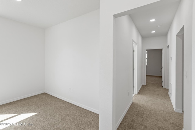 hallway featuring carpet flooring, recessed lighting, and baseboards