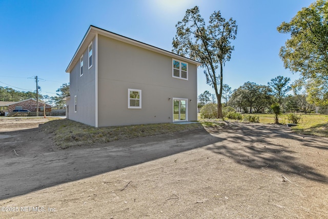 rear view of property featuring driveway