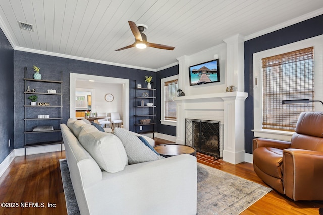 living area featuring visible vents, a fireplace with flush hearth, wood finished floors, wood ceiling, and ceiling fan