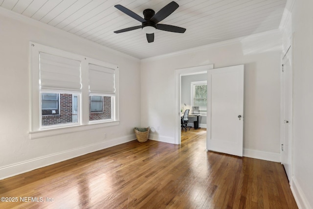unfurnished room with wood finished floors, baseboards, and ornamental molding