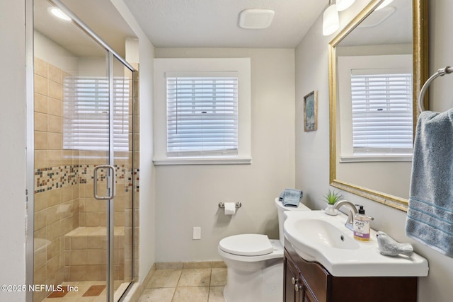 bathroom with tile patterned floors, a shower stall, vanity, and a healthy amount of sunlight