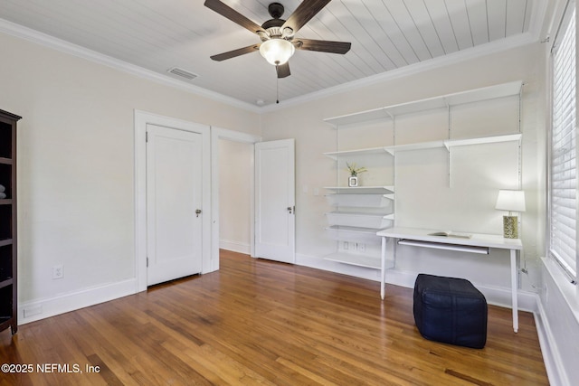 unfurnished office with baseboards, wood finished floors, ornamental molding, and a ceiling fan