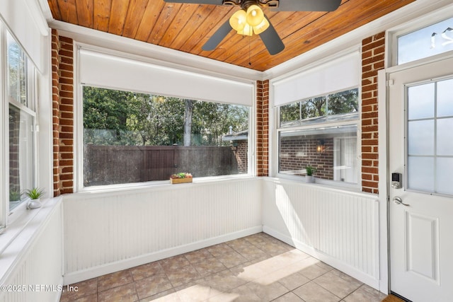 unfurnished sunroom with ceiling fan