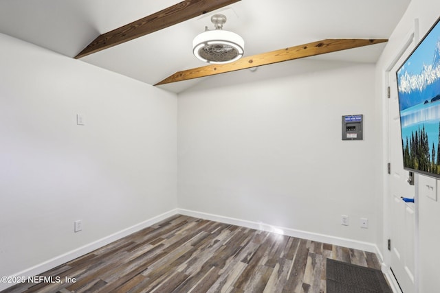 empty room with lofted ceiling with beams, baseboards, and dark wood-style flooring