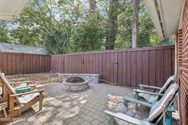 view of patio with an outdoor fire pit and a fenced backyard