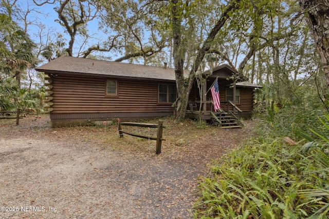 rear view of house featuring log exterior