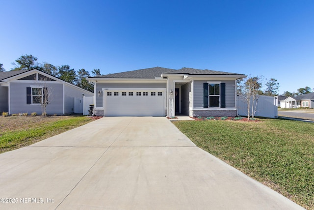 prairie-style home featuring a front lawn, driveway, an attached garage, and fence