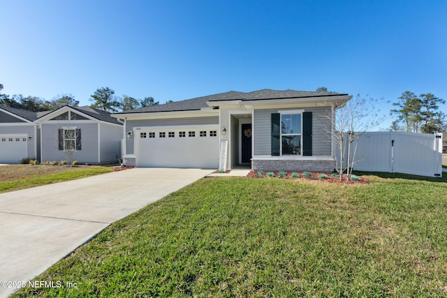 view of front of home featuring concrete driveway, a front lawn, and an attached garage