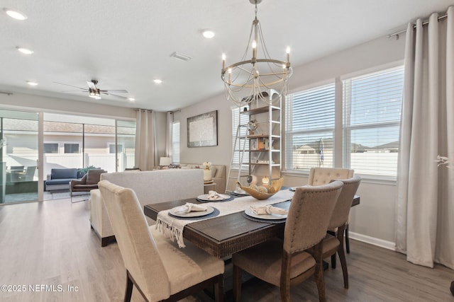 dining space with recessed lighting, visible vents, baseboards, wood finished floors, and ceiling fan with notable chandelier