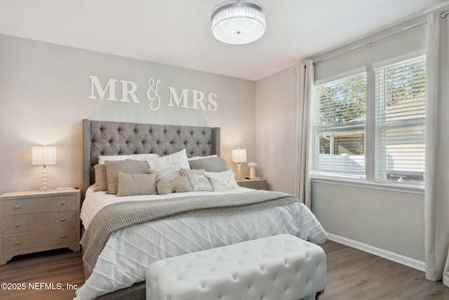 bedroom with wood finished floors and baseboards