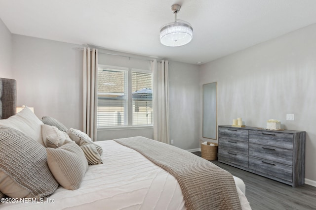 bedroom featuring baseboards and wood finished floors