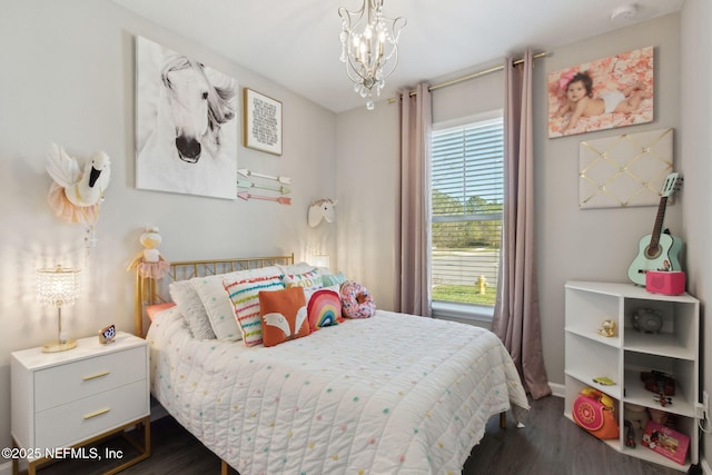 bedroom featuring a notable chandelier, baseboards, and dark wood-style flooring