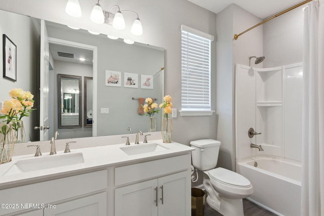 full bath featuring toilet, shower / bathtub combination with curtain, visible vents, and a sink