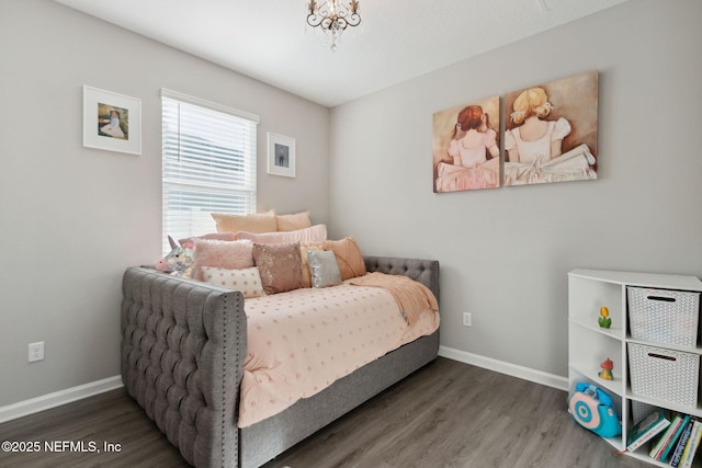 bedroom featuring baseboards and wood finished floors