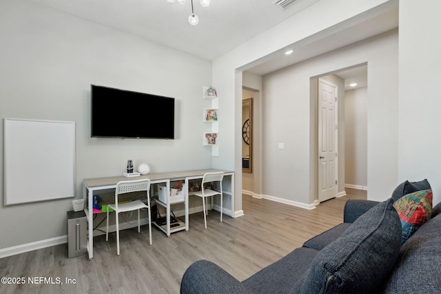 living area featuring wood finished floors and baseboards