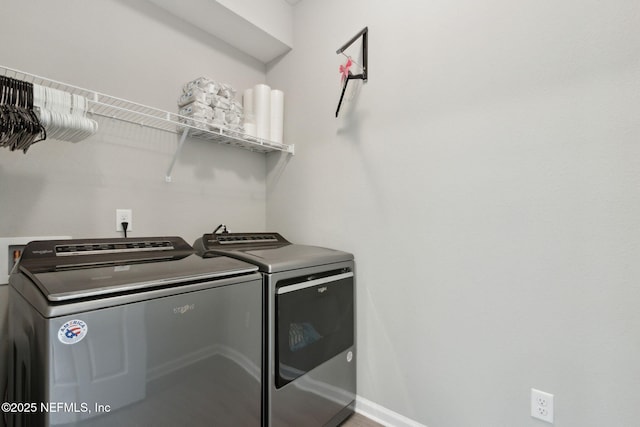 laundry area with laundry area, baseboards, and washing machine and clothes dryer