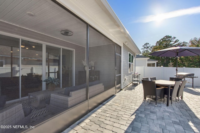 view of patio with outdoor dining area, fence, and area for grilling