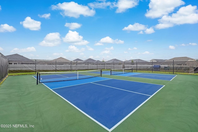 view of sport court featuring a residential view and fence