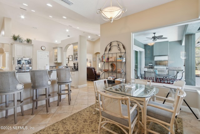 861998 N Hampton Club Way, Fernandina Beach, FL 32034 - dining area featuring vaulted ceiling, light tile patterned flooring, arched walkways, visible vents, and ceiling fan