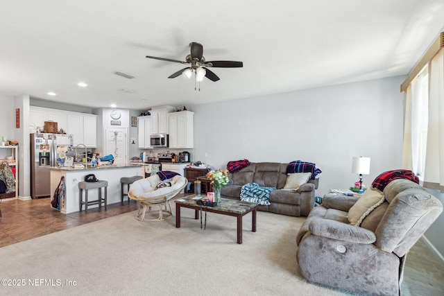 living room with recessed lighting, visible vents, ceiling fan, and carpet