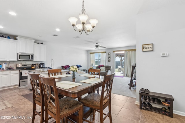 dining area featuring visible vents, baseboards, light tile patterned flooring, recessed lighting, and ceiling fan with notable chandelier