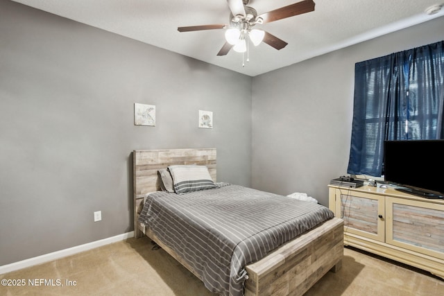 bedroom with baseboards, light colored carpet, and ceiling fan