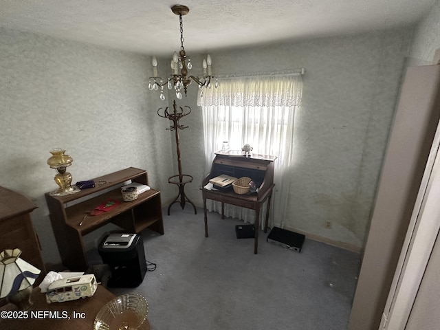 interior space with a notable chandelier, carpet floors, and a textured ceiling