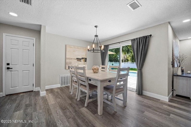 dining area with visible vents, baseboards, dark wood finished floors, and a chandelier