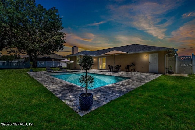 view of pool with a patio area, a yard, fence, and a fenced in pool