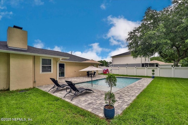 view of swimming pool with a fenced in pool, a lawn, a fenced backyard, and a patio area