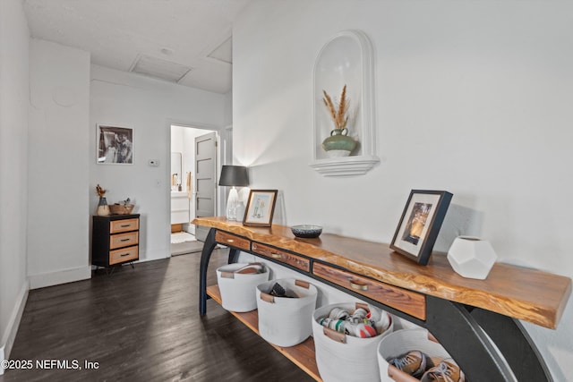 office space with baseboards, attic access, and dark wood finished floors