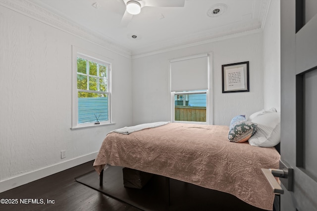 bedroom featuring ceiling fan, baseboards, wood finished floors, and ornamental molding