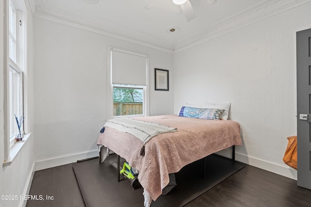 bedroom featuring ceiling fan, wood finished floors, baseboards, and ornamental molding