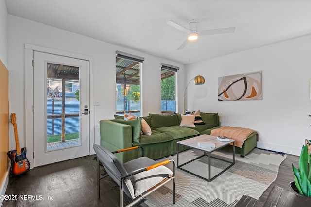 living area with ceiling fan, baseboards, plenty of natural light, and wood finished floors